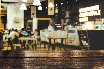 Empty wooden table space platform and blurred restaurant or coffee shop background for product display montage