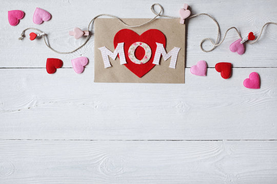 Background for congratulations for Mother's Day with card and hearts