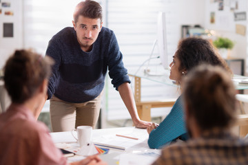 Obraz premium in a meeting. A young man presenting his project in front of his