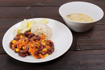 Red beans with corn and carrot, sorghum on a table