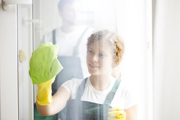 Woman cleaning window