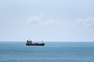 A ship tanker stands without traffic, a ship on a blue sky background