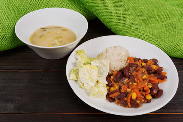 Red beans with corn and carrot, sorghum on a table