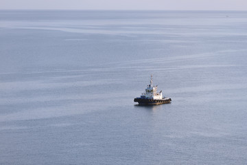 Tug boat stands without traffic in the sea. Tug boat alone in the sea