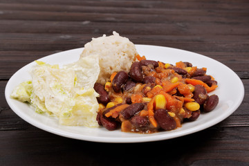 Red beans with corn and carrot, sorghum on a table