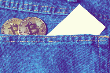 Golden bitcoins in the pocket of old vintage indigo stonewashed jeans. Concept of bitcoin - a...