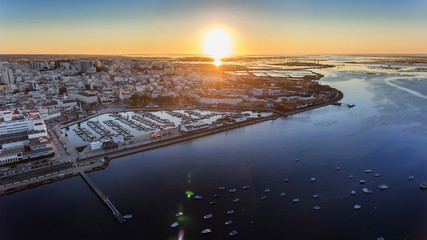 Aerial view of the sunrise over the city of Faro, Portugal. Marina.