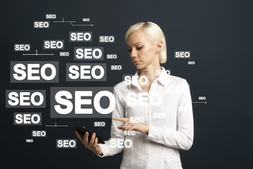 Businessman presses button seo business on phone virtual electronic user interface.