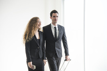 Two businesspeople discussing for partner business while walking in office building.