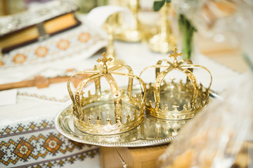 Golden crowns lying on the table in church