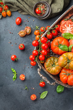 Assortment of ripe organic farmer red tomatoes on a table