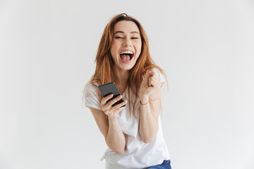 Portrait of a laughing young girl holding mobile phone