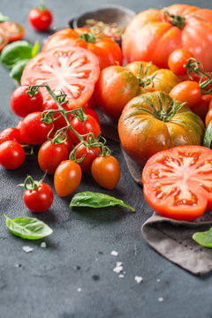 Assortment of ripe organic farmer red tomatoes on a table