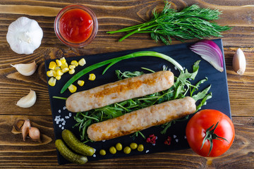 dish with sausages and vegetables, top view