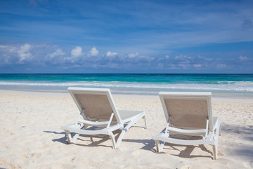 Two white beach chairs on the empty beach , Yucatan, Mexico
