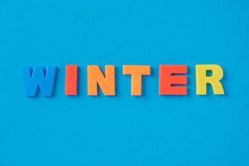 The winter inscription with plastic letters on a blue background