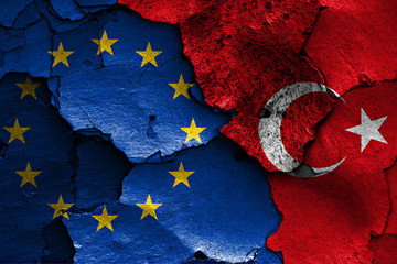 flags of EU and Turkey painted on cracked wall