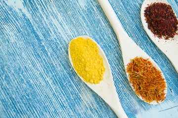 Set of spices and herbs on blue wooden background