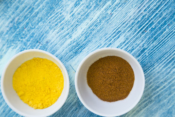 Set of spices and herbs on blue wooden background