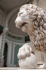 sculpture of a lion on the background of the main entrance to the palace, Vorontsov Palace in Crimea, close-up