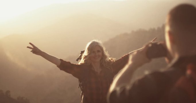 Active retired woman hiker posing for photo on mountain top