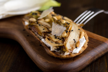 Roast Organic Chicory on Bread Slice with Pine Nuts and Black Sesame. Organic Healthy Food.