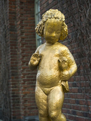 Fototapeta na wymiar Close-up of golden statue of girl with flower, Stockholm, Sweden