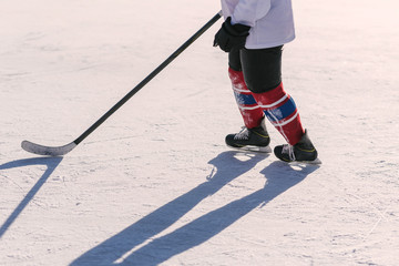 the man plays hockey on the rink