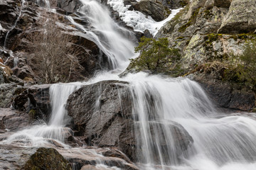 Fototapeta na wymiar Waterfall from snow melt in the mountains of Madrid, Spain