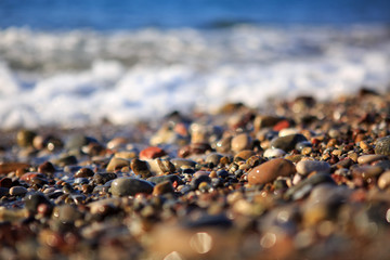 Waves washing over gravel beach, macro shot.