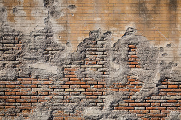 Weathered plaster and brick wall textured background 