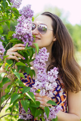 young girl smelling lilac park sunglasses spring