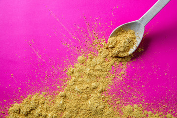 excess of spicy food in wooden gourmet spoon for seasoning