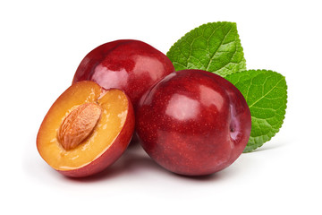 Isolated plums. One and a half of red plum fruit with leaves isolated on white background.