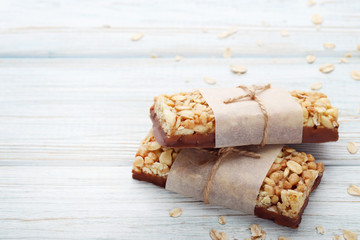 Tasty granola bars on wooden table