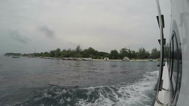 boat comes to gili travangan cloudy rain season