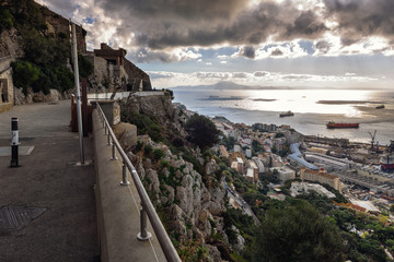 Dark stormy clouds over Gibraltar bay.Aerial view tourist promenade at top of the rock