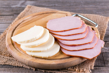 Sliced ham and cheese on a cutting board