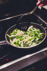 frying pan with sauteed onions and shallot being cooked