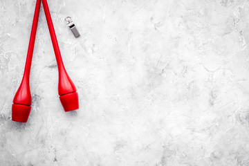 Maces for rhythmic gymnastics on grey background top view copy space