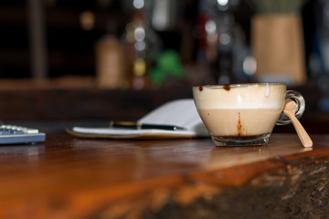Pen and notebook on coffee table in coffee shop