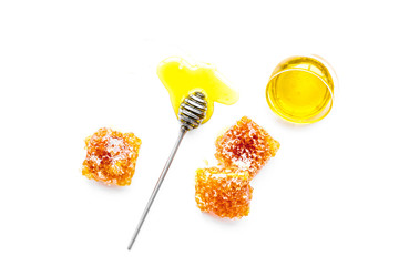 Honey background. Honey dipper and honeycomb on white background top view
