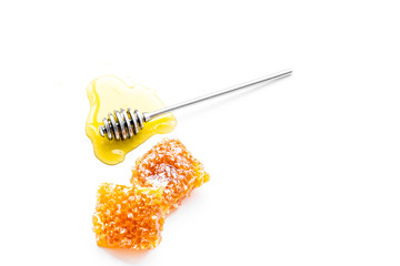 Honey background. Honey dipper and honeycomb on white background top view copy space