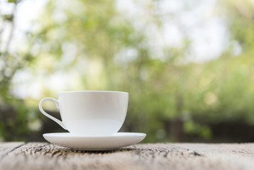Close up white coffee cup on the table at morning time