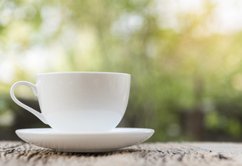 Close up white coffee cup on the table at morning time