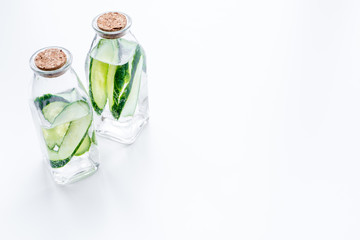 Drink for weight loss. Water with cucumber on white background top view copy space