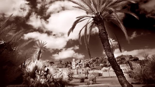 Monotone, wide shot, time-lapse of traditional Berber village in the Ameln Valley of the Anti-Atlas mountains in Morocco.