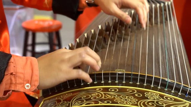 Chinese traditional musician playing Chinese guzheng
