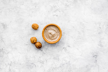 Homemade spa with organic scrub and walnut on stone background top view space for text © 9dreamstudio