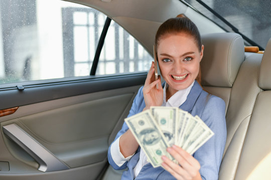 Business Concepts. Beautiful Businesswoman In A Car. A Business Woman Is Traveling By Car. Business Women Are Holding Money Happily.